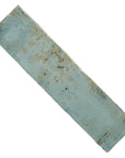 Closeup of distressed look aqua blue ceramic 3x12 subway tile