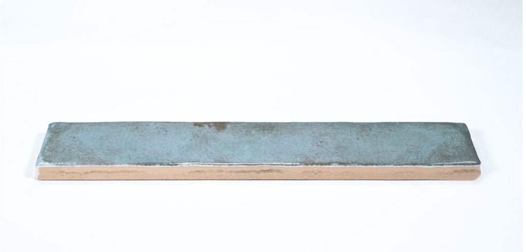 Closeup of a blue-green subway tile 