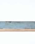Closeup of a blue-green subway tile 