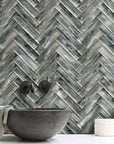 Bathroom Backsplash Featuring Blue Gray Wood Grain Textured Glass Subway Tile in Herringbone Layout Pattern