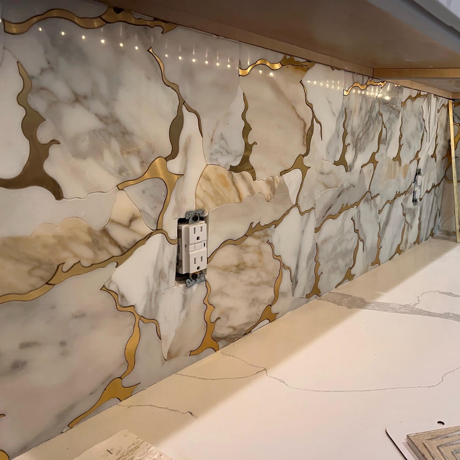 Calacatta Gold Marble and Brass Waterjet Mosaic Tile in Geode