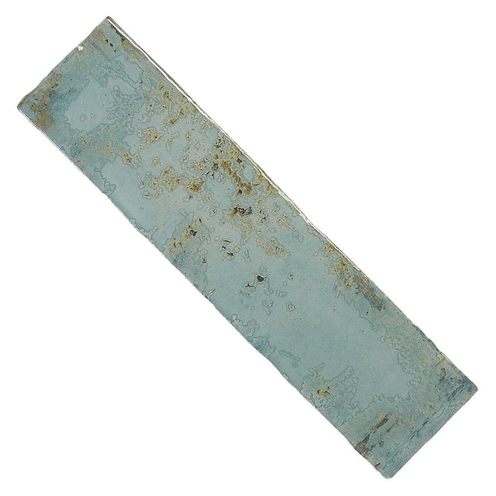 Closeup of distressed look aqua blue ceramic 3x12 subway tile