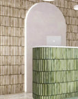 Beige Kit Kat Tile Wall Behind Green Tiled Reception Desk
