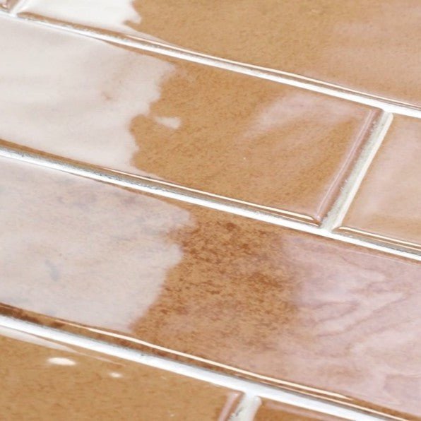 Closeup of Glossy Terracotta Orange 3x11 Distressed Porcelain Tiles