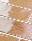 Closeup of Glossy Terracotta Orange 3x11 Distressed Porcelain Tiles