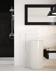 White and black bathroom with open shower, modern vanity area, and white 3D wavy tile wall.