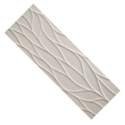 Closeup of a single large format wave pattern 3D tile in off-white.