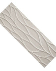 Closeup of a single large format wave pattern 3D tile in off-white.