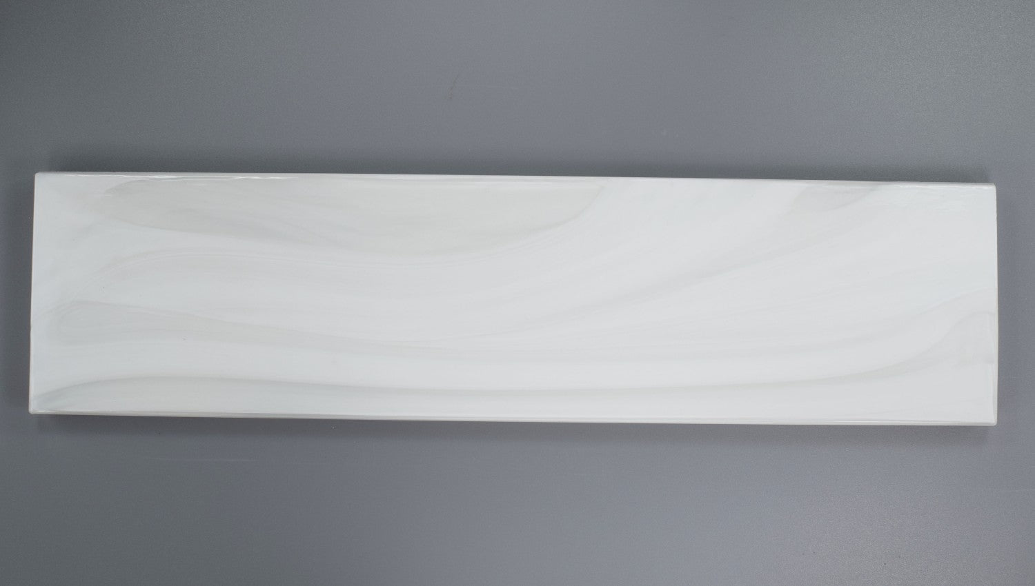 Closeup of a 3x12 White Pearlescent Glazed Glass Subway Tile